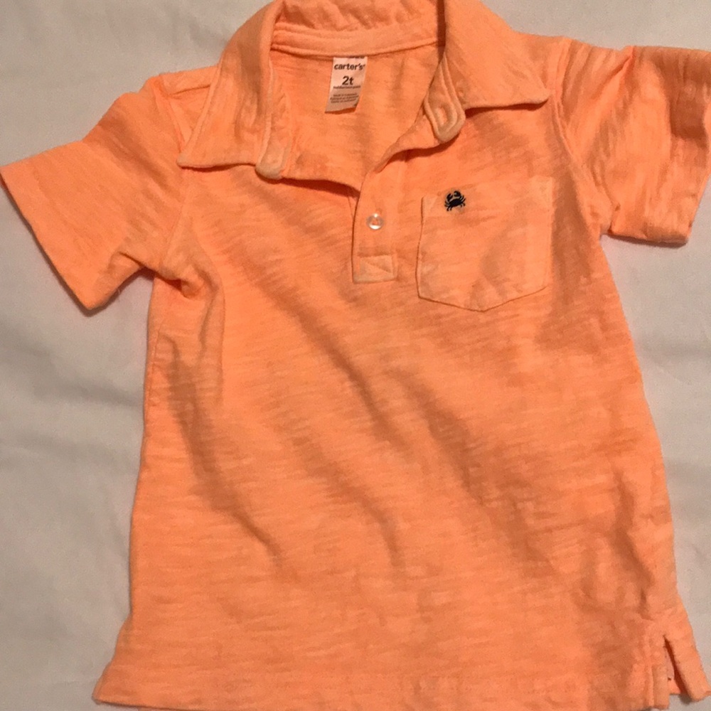 Carter’s orange polo with crab emblem